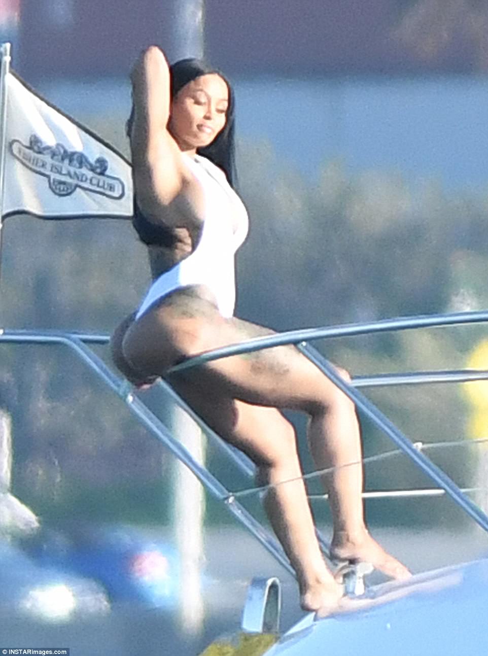 Blac Chyna shows off bodacious behind and cleavage in plunging one-piece thong swimsuit on yacht in Miami
