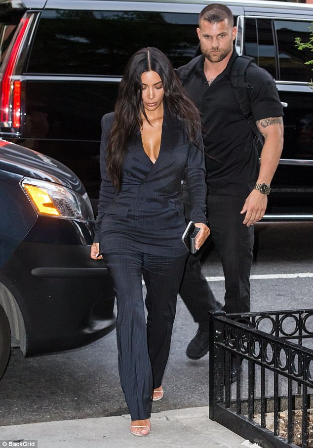 Protecting her most important asset! Kim Kardashian’s bodyguard puts his hand near her curvy derriere