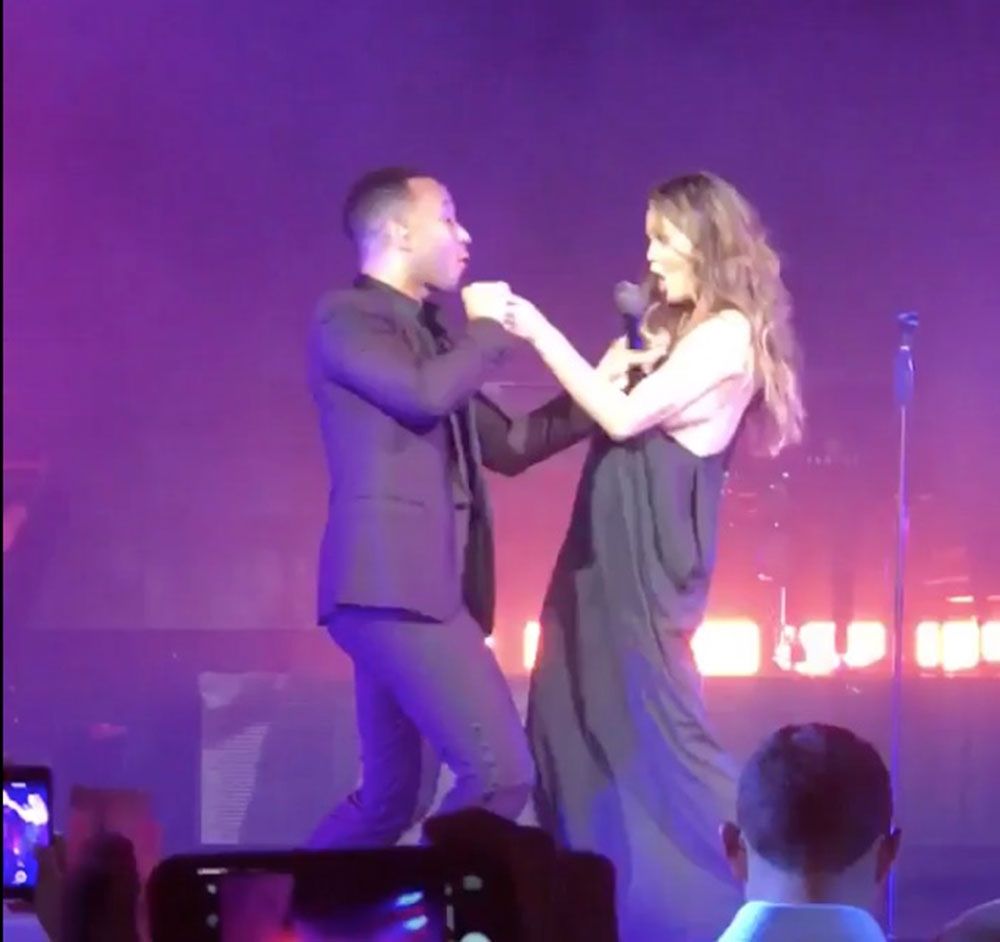 Watch in awe as Chrissy Teigen deals with her whole boob coming out on stage like a pro